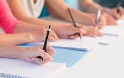 students writing on paper